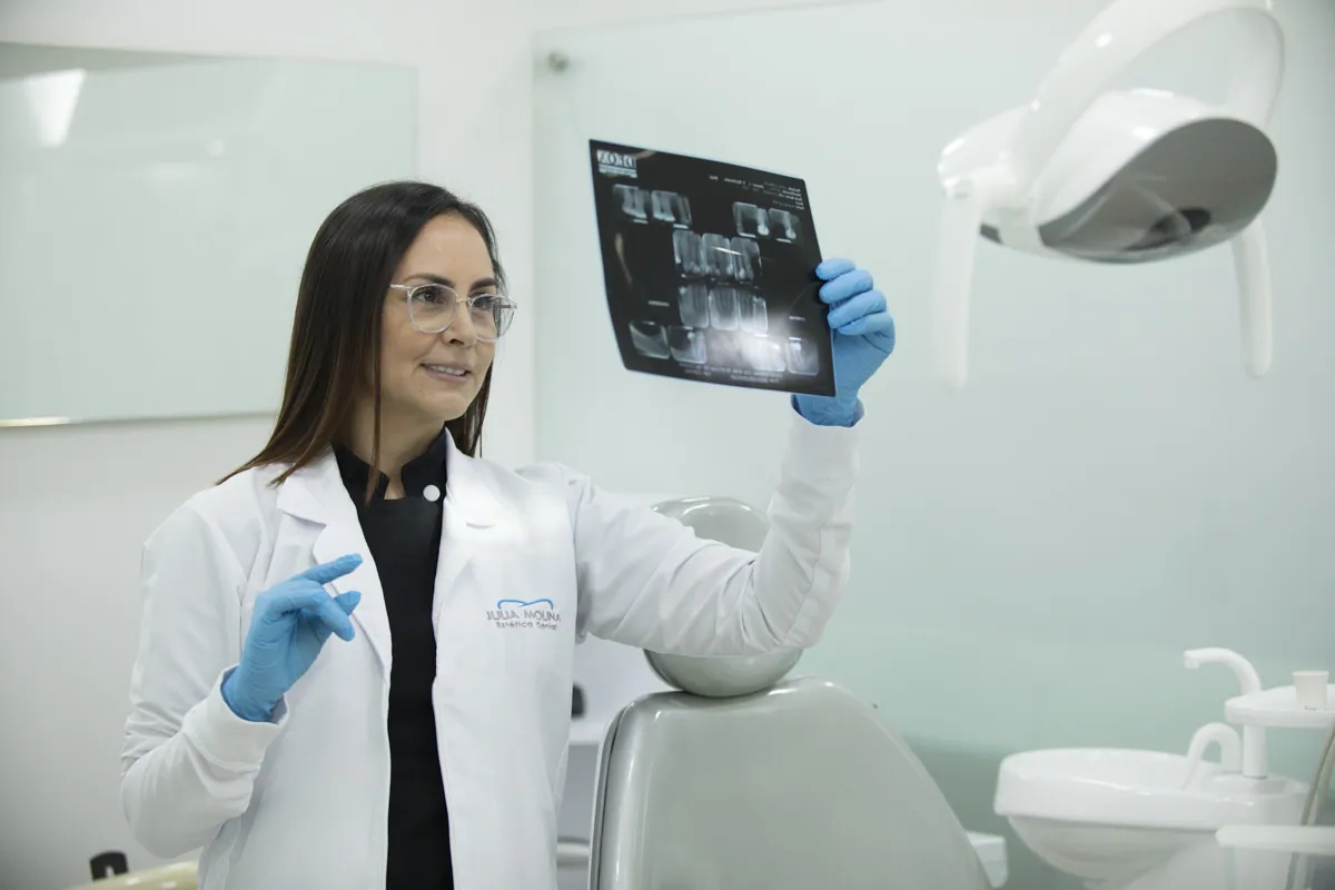 Dr. Julia Molina reviewing a dental X-ray at her clinic in Colombia