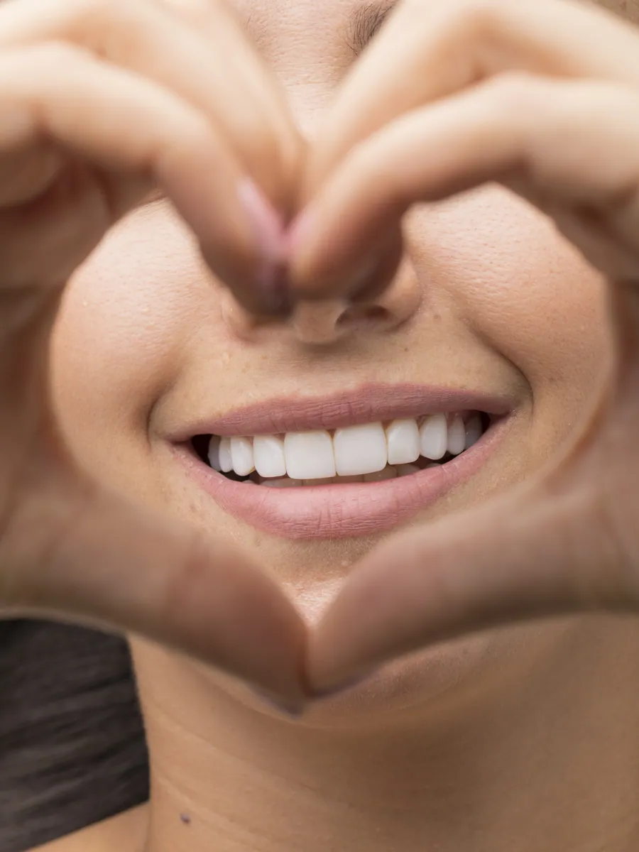 Patient showing her natural smile after treatment in Colombia